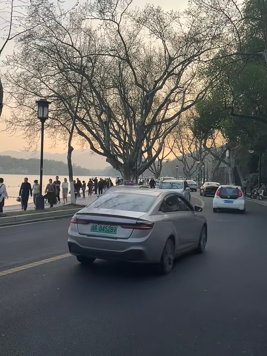 傍晚湖边的银车，车牌B45289，像在拍电影