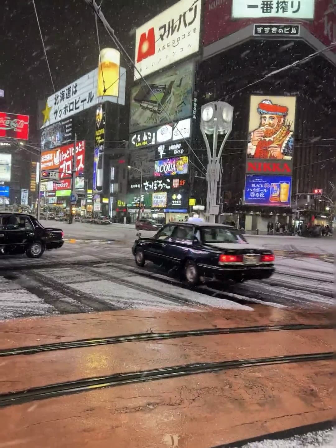 雪夜的札幌街角,黑色出租车裹着雪冲过斑马线封面图